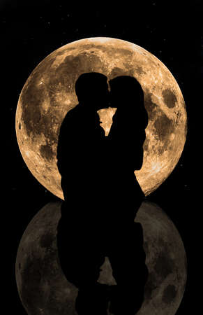 Kiss on the background of the moon  Silhouette image の写真素材