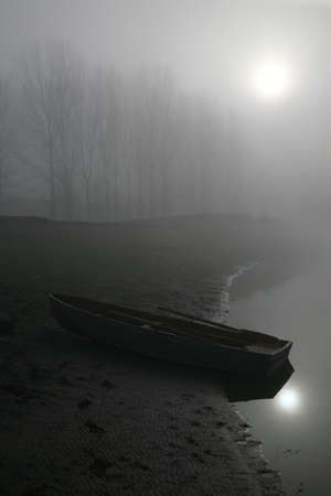 The boat on the shore  Early foggy morning の写真素材