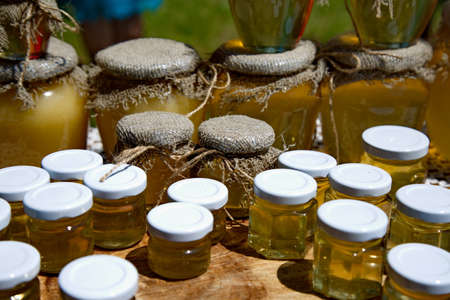 Several jars of honey on the trade counter.の写真素材