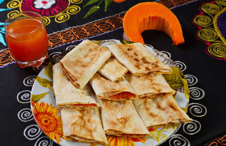 Pies in plate and a glass of pumpkin juice.の写真素材