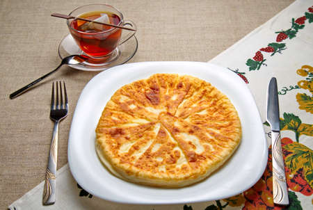 Patties with cheese and a cup of tea.の写真素材