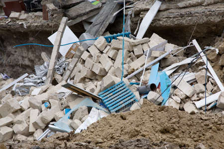 Room sections in the half-destroyed building. The collapse of the wall.