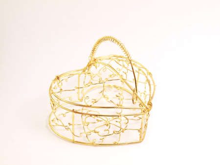golden iron basket on the white backgroundの写真素材