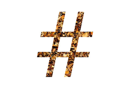 hashtag of the alphabet made with brown wood shredder, isolated on a white background