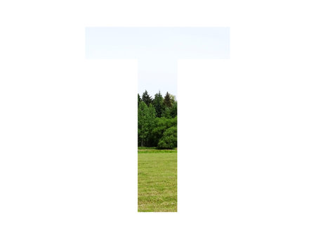Letter t of the alphabet made with landscape with grass, forest and a blue sky, isolated on a white backgroundの写真素材