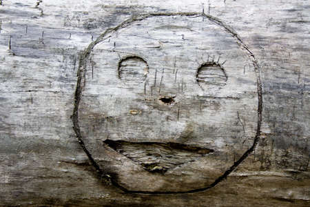 smile graven a long time ago in woodの写真素材