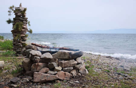 Pebble hearth and pillar on the Baikal beachの写真素材