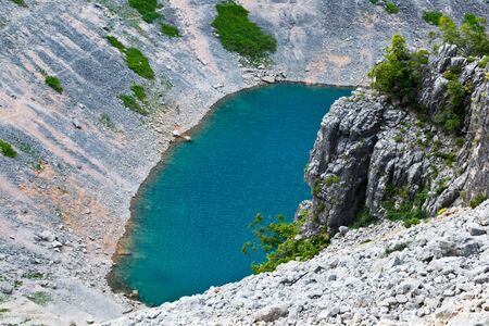 Imotski Blue Lake in Limestone Crater near Split, Croatiaの写真素材