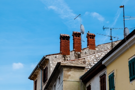 Three Red Chimneys on Roof in Porec, Croatiaの写真素材