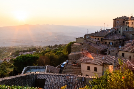 Sunset and Rays of Light in Small Town Volterra at Sunset in Tuscany, Italyの写真素材