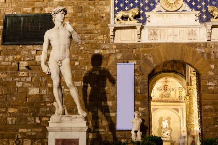 Michelangelo's David Sculpture and its Shadow in the Night, Piazza della Signoria, Florence, Italyのeditorial素材