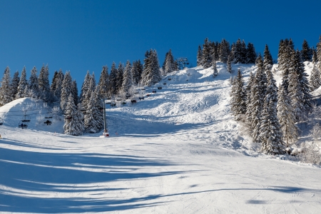 Sunny Ski Slope and Ski Lift near Megeve in French Alps, Franceの写真素材