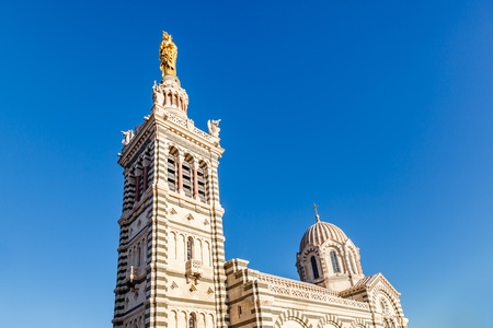 Golden Statue of the Madonna Holding the little Jesus on the top of Notre-Dame de la Garde in...