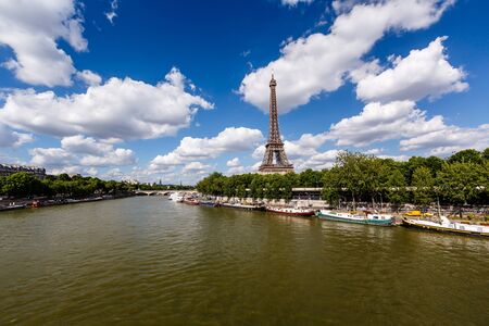 Eiffel Tower and Seine River with White Clouds in Background, Paris, France