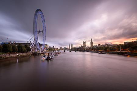 LONDON - OCTOBER 6: London Eye and Westminster Palace on October 6, 2014 in London. The largest Ferris Wheel in Europe, structure of the London Eye is 135 meters tall and 120 meters in diameter.のeditorial素材