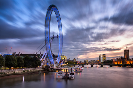LONDON - OCTOBER 6: London Eye and Westminster Bridge on October 6, 2014 in London. The largest Ferris Wheel in Europe, structure of the London Eye is 135 meters tall and 120 meters in diameter.のeditorial素材