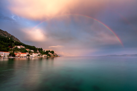 Rainbow over the Small Village in Omis Riviera after the Rain Dalmatia Croatiaの写真素材