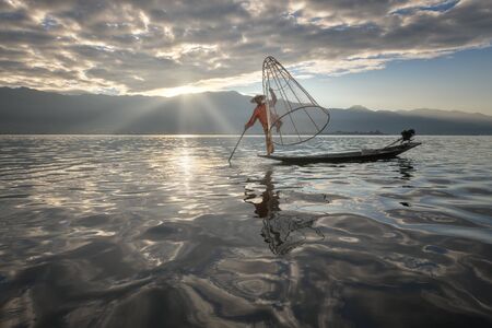 nle Lake, Myanmar - November 14, 2018: Burmese Fisherman on the Boat with Traditional Conical Net in the Morning, Lake Inle, Myanmarのeditorial素材