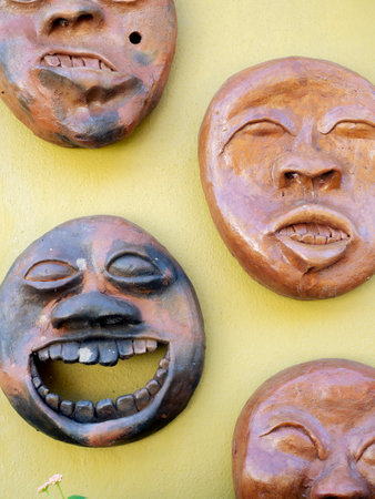 Wooden masks on the wall of a house in the town of Mae Salong north of the city Chiang Rai in North Thailand.
four face masks depicting fantasy expressions on each human faceの写真素材