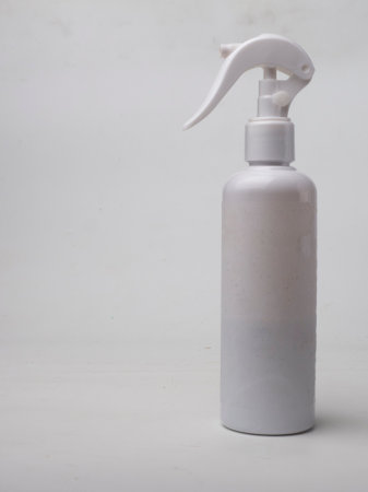 white plastic spray bottle on a white background. copy space for textWhite bottle of cosmetic product with blue towel on a white background.a white spray cosmetic bottle.の写真素材