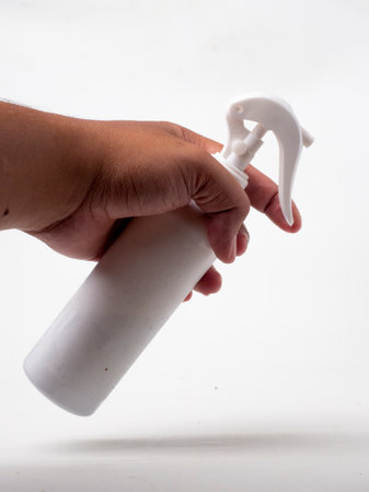 Spray bottle in hand on white background. Cleaning concept.
clothing fragrance spray, white in...