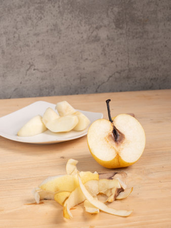 sliced pear on a wooden table, concept of healthy eatingの写真素材