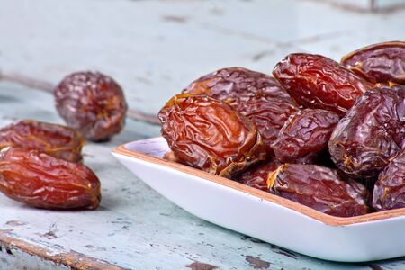 Dried dates on rustic wooden backgroundの写真素材