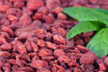 Goji berries and mint leaves close-upの写真素材