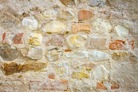 Rustic Tuscan antique stone wall backgroundの写真素材