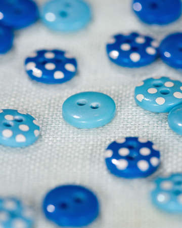 Blue buttons on linen fabric, selective focusの写真素材