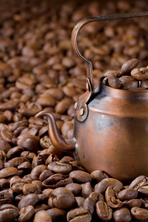 Old small rustic coffee pot with light roasted coffee beansの写真素材