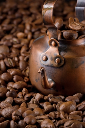 Small copper coffee pot with light roasted coffee beans, selective focusの写真素材