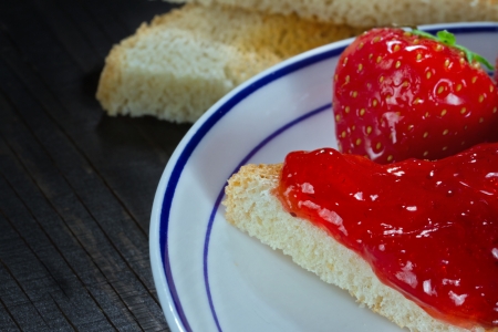 Toast with strawberry jelly on dark wooden backgroundの写真素材