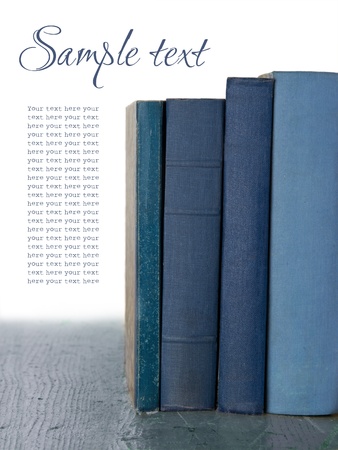 Blue old books on wooden rustic background isolted on whiteの写真素材