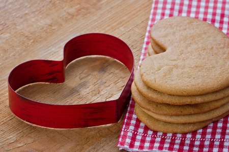 Gingerbread cookies on rustic wooden background, with heart shapeの写真素材