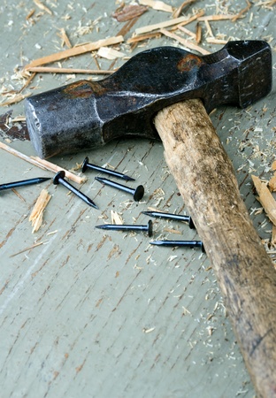 Old rustic hammer on wooden background - DIY conceptの写真素材