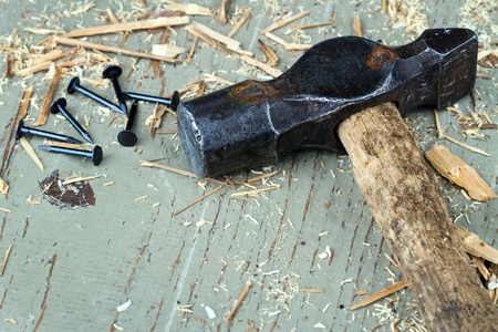Rustic old hammer with black nails on old green wooden background - DIY conceptの写真素材