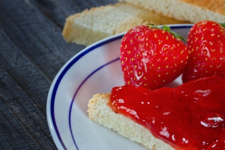 Strawberry jam on toast, black wooden backgroundの写真素材