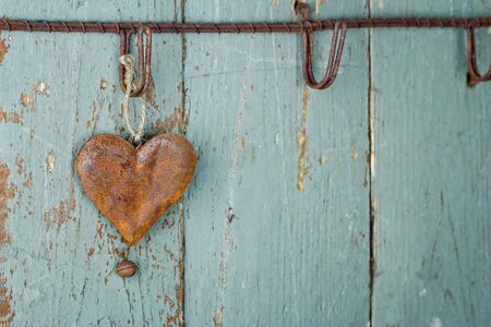 Rusty old heart on wooden rustic green backgroundの写真素材