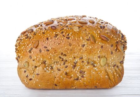 Healthy bread with seeds on white wooden tableの写真素材