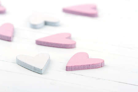 Little wooden hearts on white rustic table, selctive focusの写真素材