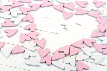 Decorative pink and white little hearts on wooden backgroundの写真素材