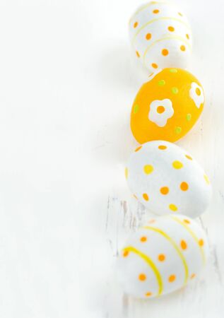 Small yellow painted easter eggs, with copy space and selective focusの写真素材
