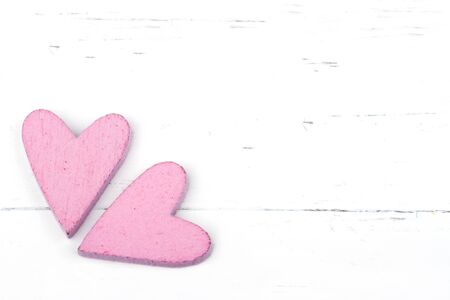 Two pink hearts on old white wooden backgroundの写真素材