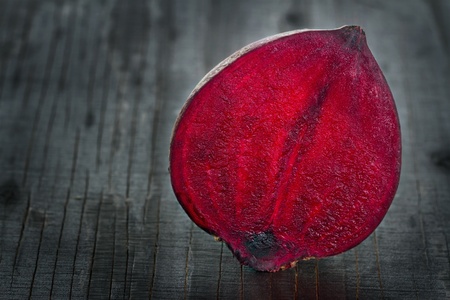 Closeup of red beet on dark wooden backgroundの写真素材