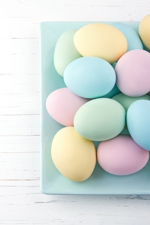 Colorful pastel easter eggs on white wooden backgroundの写真素材