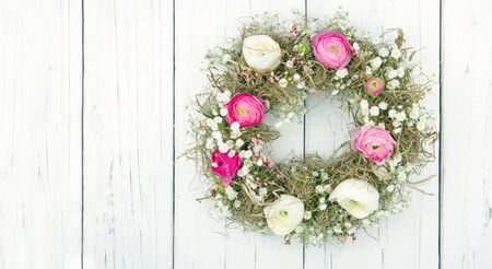 Pink and white summer flower wreath on white wooden rustic backgroundの写真素材