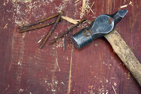 Old rustic hammer on old red wooden background - DIY conceptの写真素材