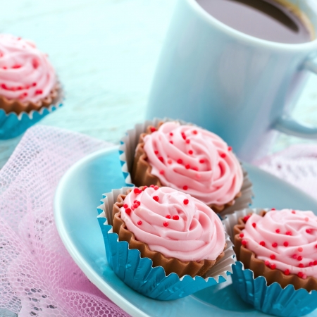 Chocolate cupcake pralines with coffee on blue plateの写真素材