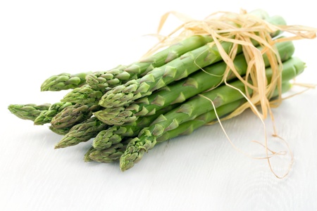Fresh asparagus closeup on white wooden backgroundの写真素材